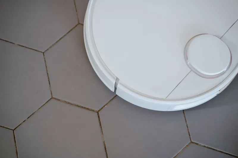 Close-up of a robotic vacuum cleaner on hexagonal tiles for efficient cleaning